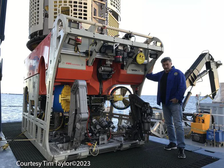Expedition ROV on the deck of a ship with Tim Taylor standing beside it